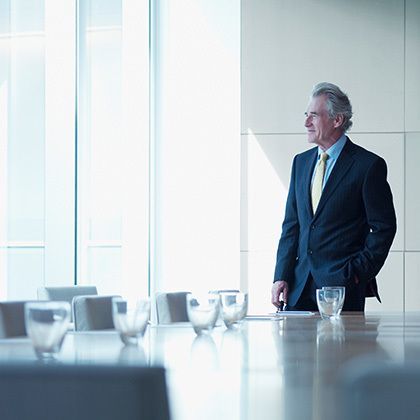 businessman standing alone in conference room